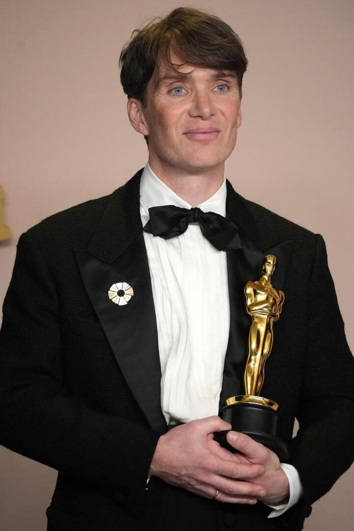 Person holding an Oscar award.