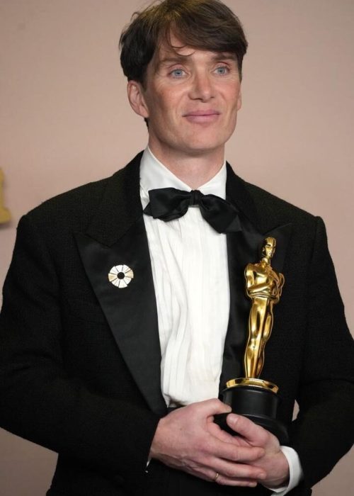 Person holding an Oscar award.